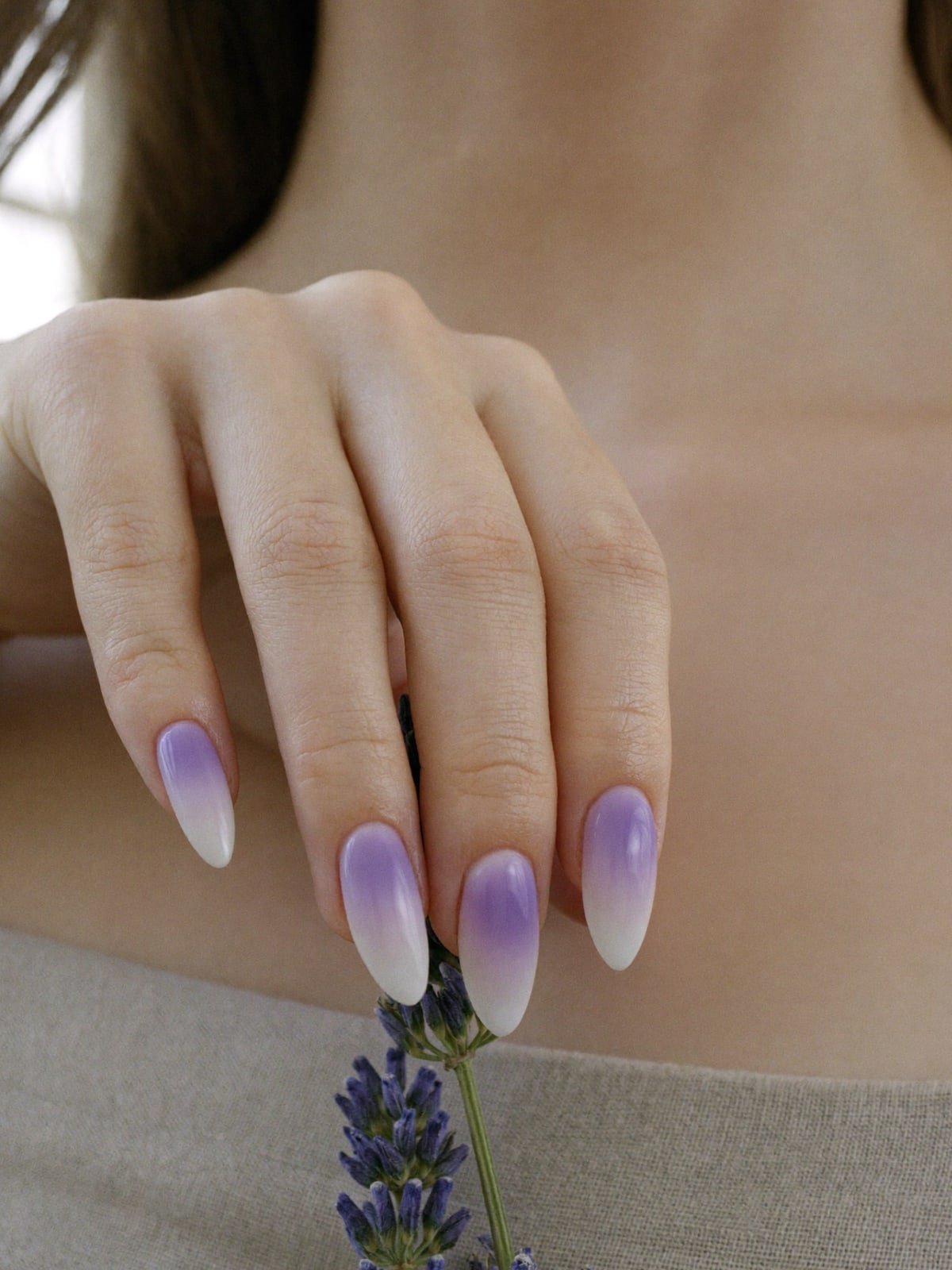 Aura Lilac press-on nails worn on hand — Medium almond · Aura ombré
