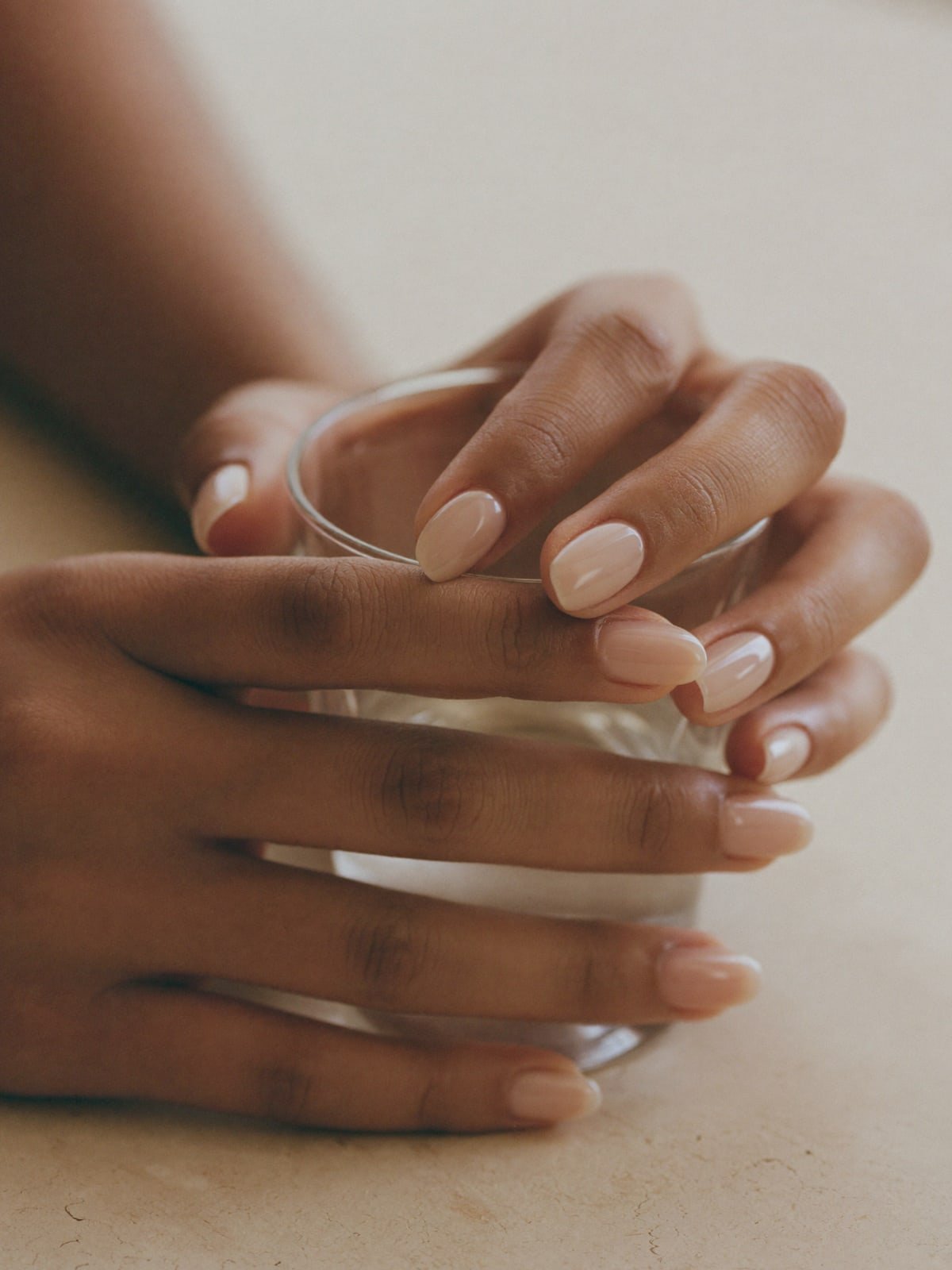 Bare press-on nails worn on hand — Short oval · Natural jelly nude