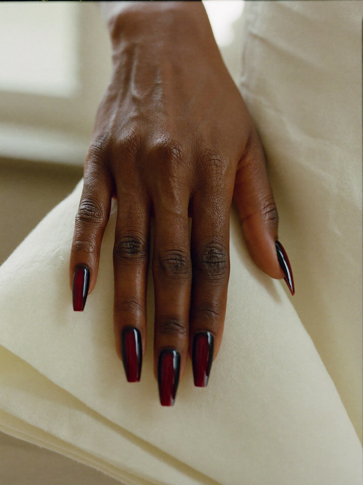 Cherry Noir press-on nails worn on hand — Medium coffin · High-gloss black cherry