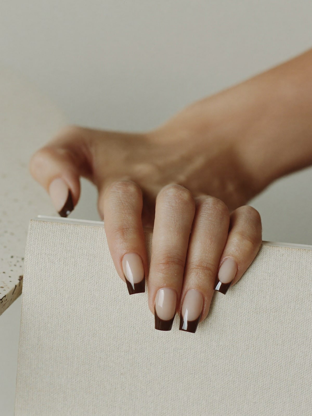 Espresso French press-on nails worn on hand — Medium square · Espresso tip
