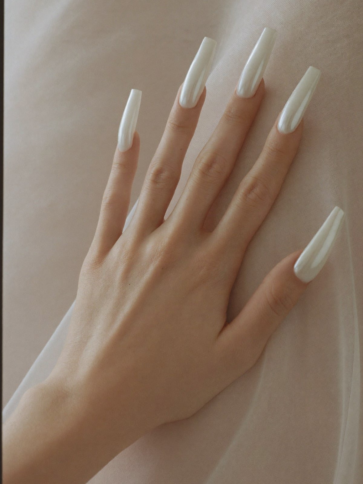 Pearl Ballerina press-on nails worn on hand — Long coffin · Pearl chrome