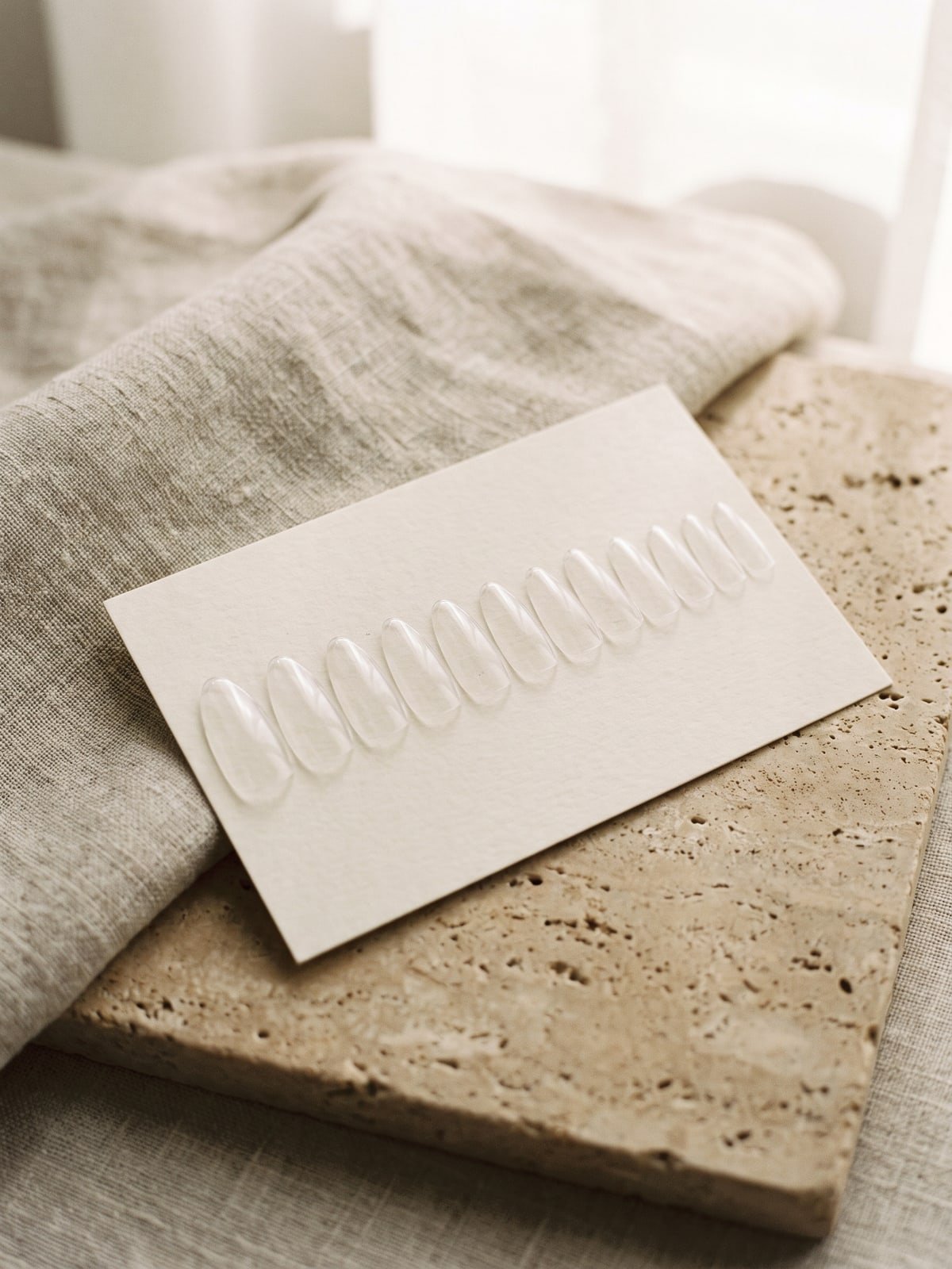 Clear sizing tips arranged on a card